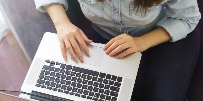 a person typing on a laptop