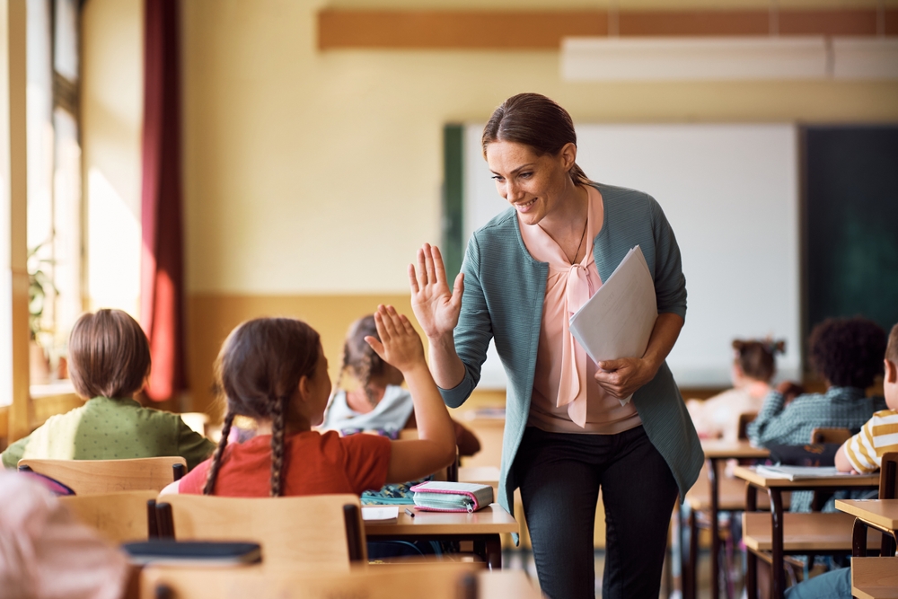 HappyElementarySchoolTeacherGivingHigh-fiveToHerStudentDuring | LG Networks, Inc. IT support for nonprofits